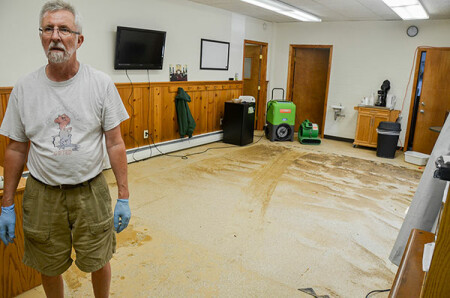 Richard Blood, a trustee at Emory UMC in Ellicott City, stands in the church&rsquo;s Education Building Aug. 1 as they work to clean up from the flash flood of Saturday, July 30. Photo by Alison Burdett.