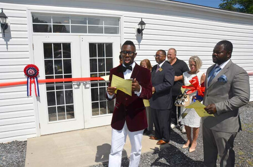Pastor Michael Carrington of St. Luke’s UMC in Reisterstown leads a dedication service for an extension on the church, including the first attached bathrooms in the 136-year history of the congregation. Photo by Erik Alsgaard.